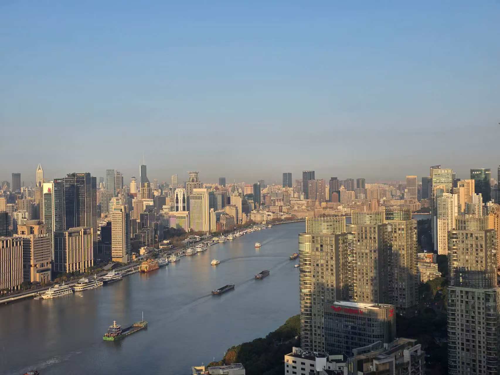 Shanghai's riverside skyline and boats on the Huangpu