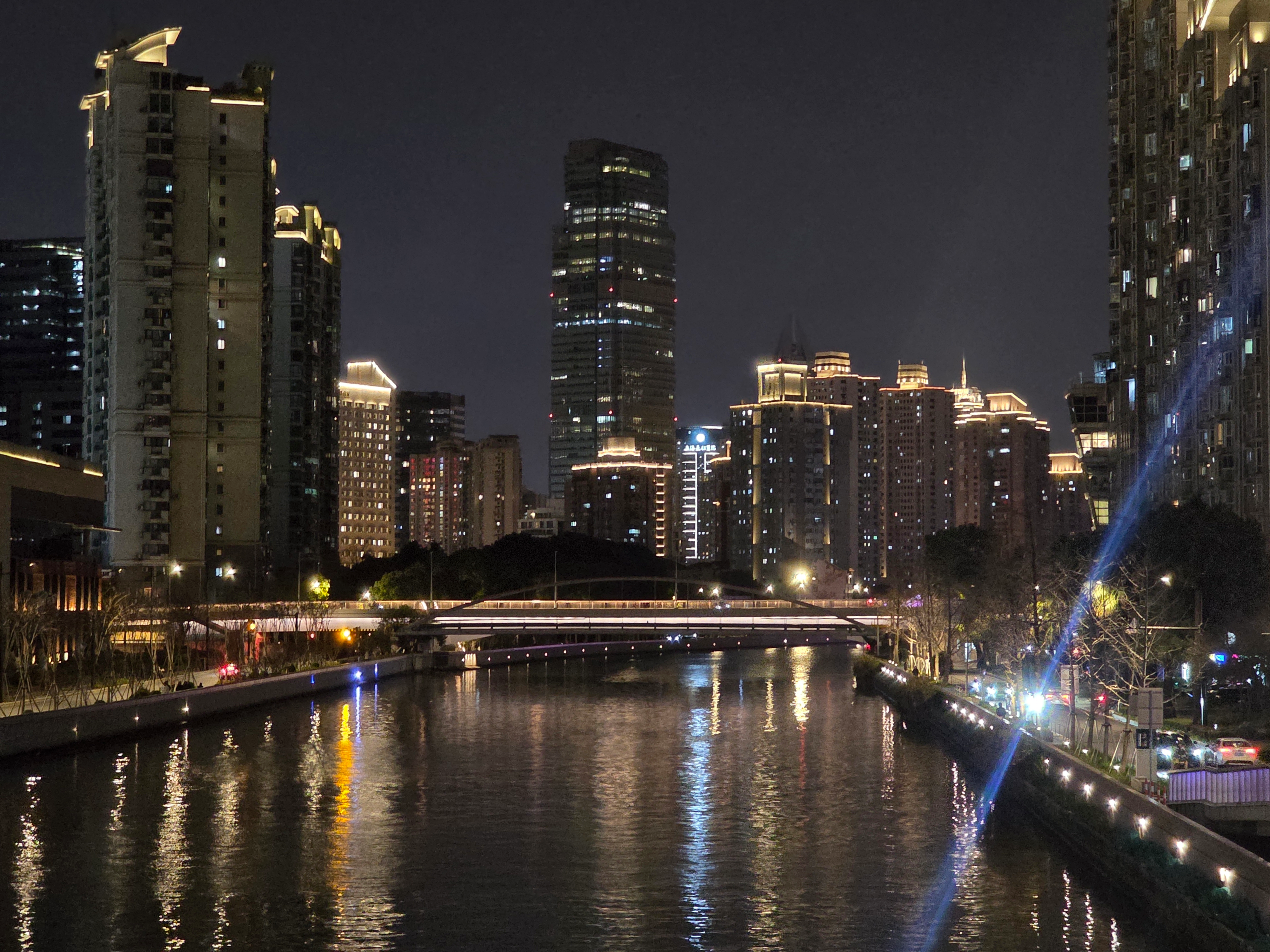 Shanghai's skyline reflected in the water at night